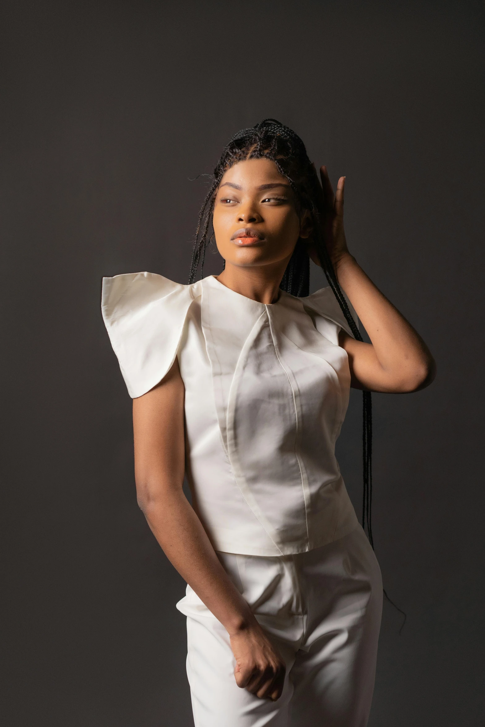 a woman in a white top and white pants, inspired by Chinwe Chukwuogo-Roy, afrofuturism, large shoulders, curated collections, silver，ivory, silky texture