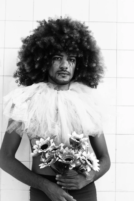 a man standing in a bathroom holding a bouquet of flowers, an album cover, inspired by Candido Bido, funk art, ((portrait)), colorless, big hair, showstudio