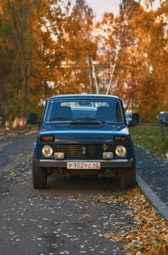 a blue truck parked on the side of a road, an album cover, by Sven Erixson, pexels contest winner, renaissance, russian lada car, autum, 256x256, suburban