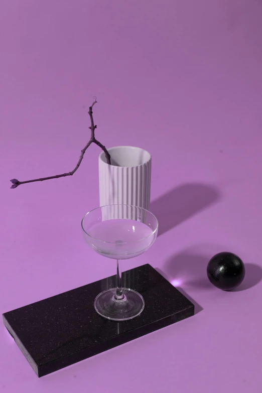 a white vase sitting on top of a table next to a black object, a still life, inspired by Robert Mapplethorpe, trending on unsplash, magic realism, drinking a martini, purple themed, 3 d object, with black vines