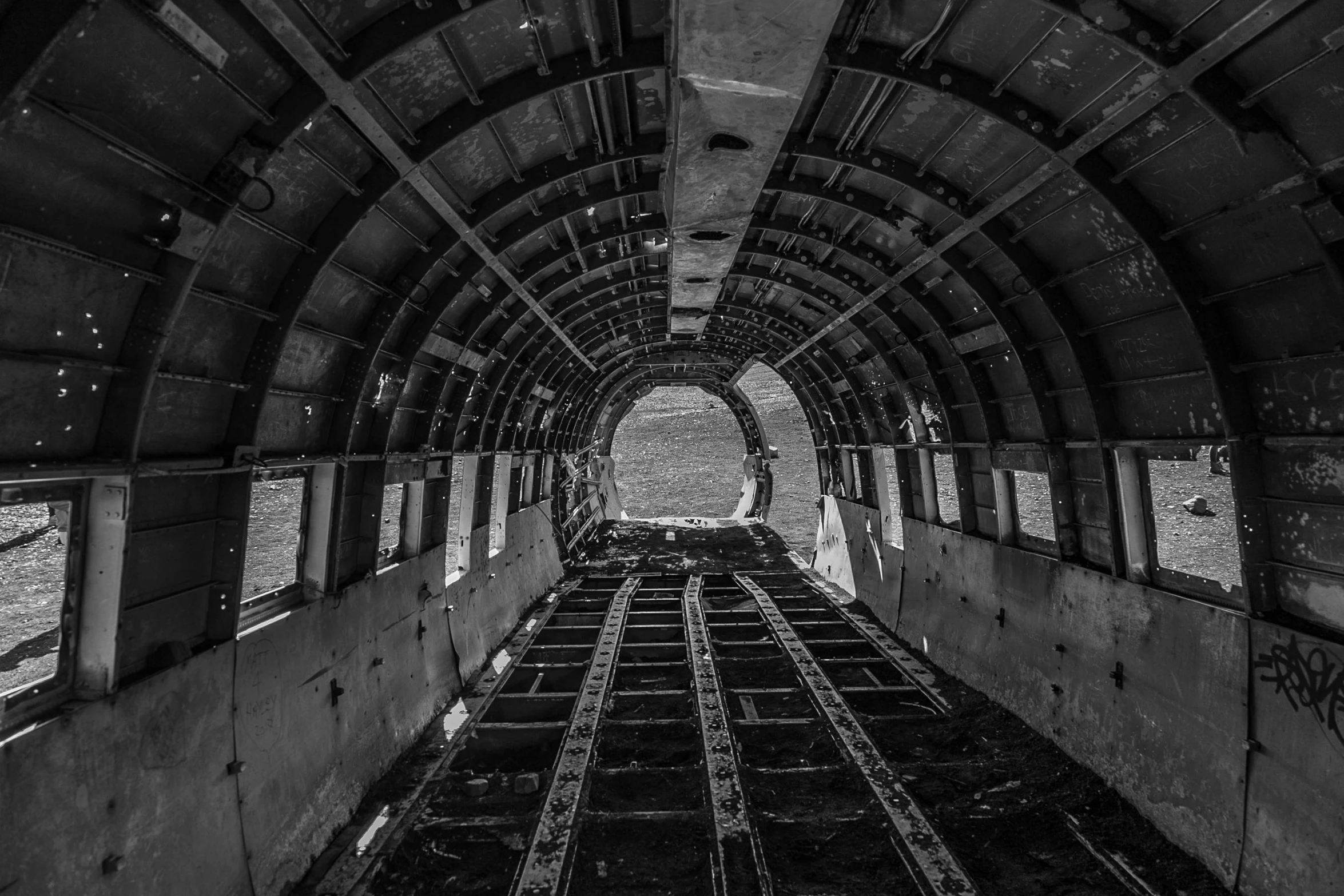 a black and white photo of a train tunnel, by Jeffrey Smith, pexels contest winner, surrealism, fallout airplane concept art, junk on the ground, simple airplane cockpit, under construction