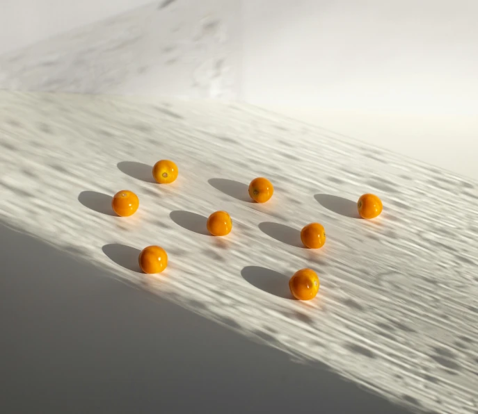 a group of oranges sitting on top of a table, a marble sculpture, inspired by Michelangelo Unterberger, unsplash, conceptual art, many floating spheres, smooth surface render, 2022 photograph, pills