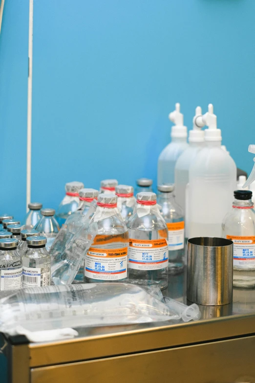 a bunch of bottles sitting on top of a table, surgical equipment, detailed product image, acids, blue