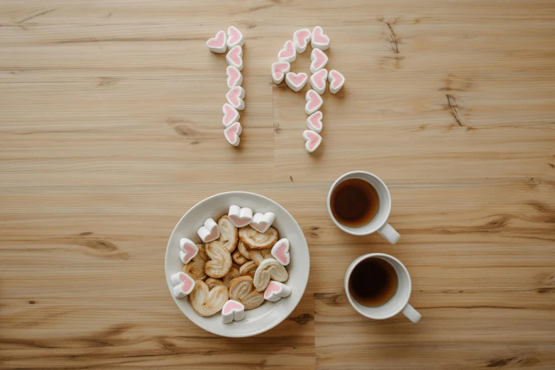 a bowl of marshmallows next to a cup of coffee, by Julia Pishtar, trending on pexels, aestheticism, four years old, pizza on a table, numerical, 1 4 9 3