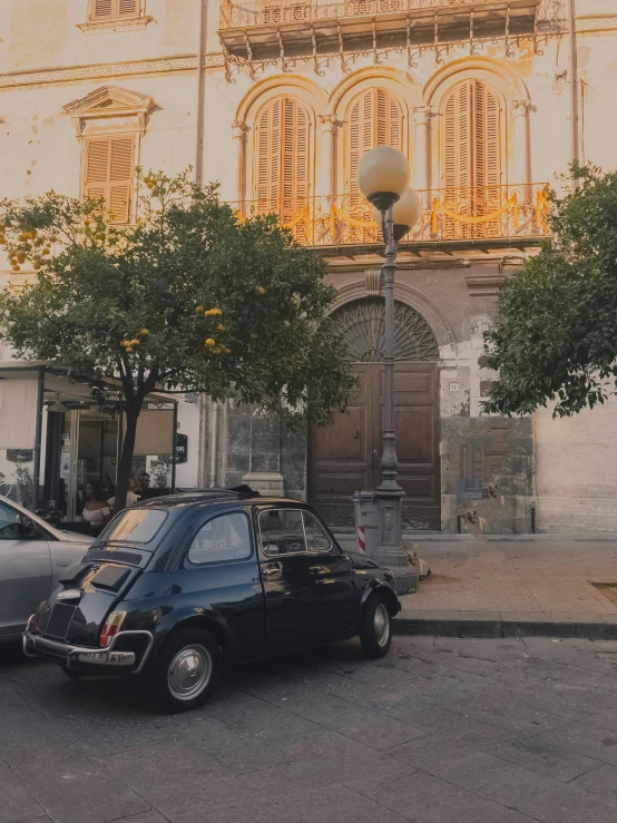 a couple of cars that are parked in front of a building, by Carlo Martini, pexels contest winner, renaissance, palermo city street, low quality photo, french bob, gif