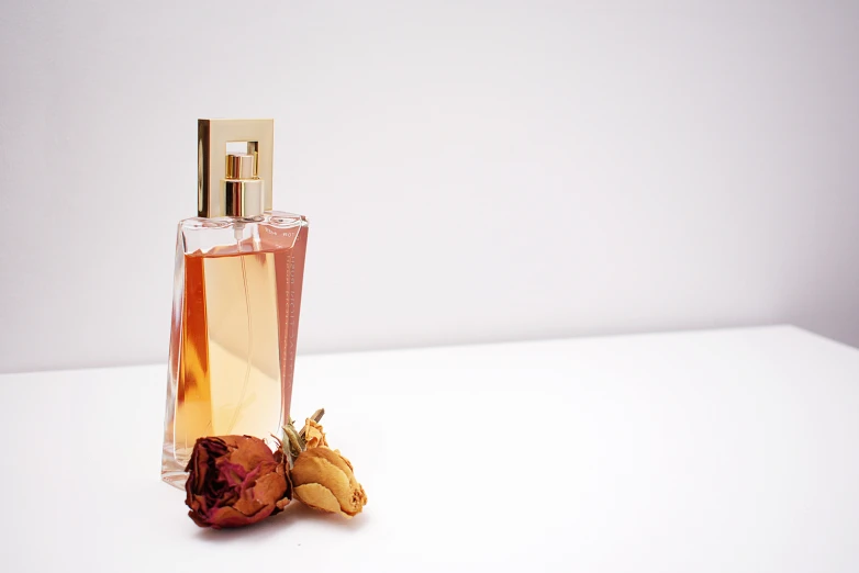 a bottle of perfume sitting on top of a white table, thumbnail, rosses, profile image, ginger