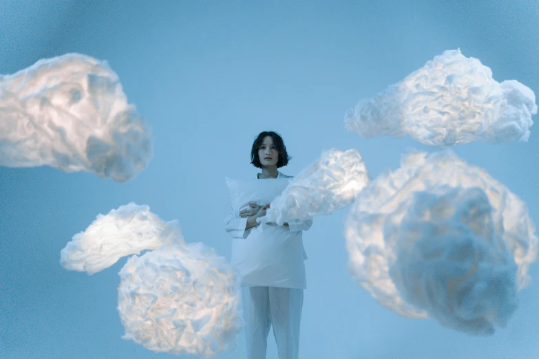 a woman in a white dress is surrounded by clouds, an album cover, inspired by Fei Danxu, cryogenic pods, in white room, promo image, shot with sony alpha