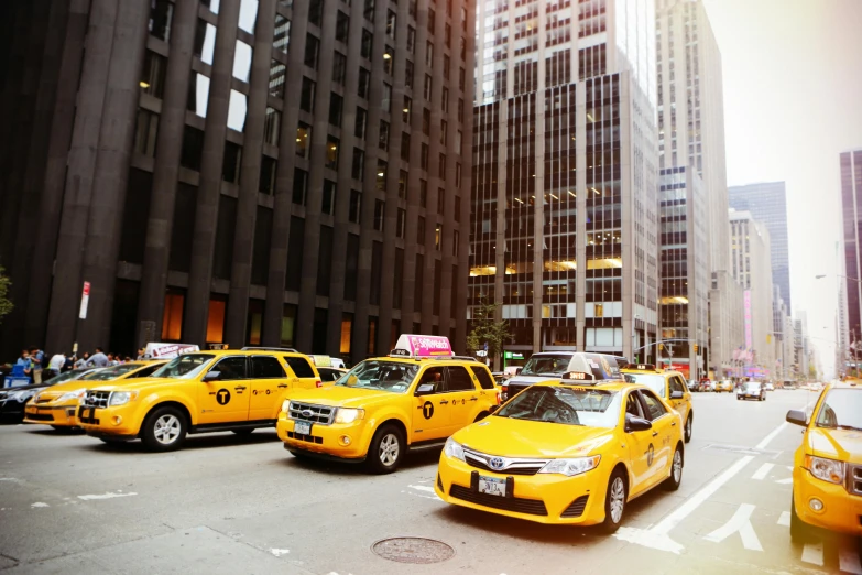 a city street filled with lots of yellow cabs, pexels contest winner, square, ny, high quality photo, 1 4 9 3