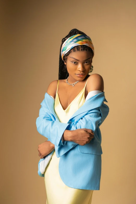 a woman in a yellow dress and a blue jacket, inspired by Chinwe Chukwuogo-Roy, trending on pexels, renaissance, zendaya, wearing a head scarf, wearing a light blue suit, cute elegant pose