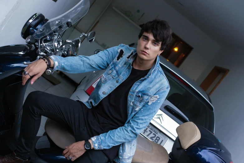 a man sitting on the back of a motorcycle, an album cover, inspired by Adam Dario Keel, pexels contest winner, photorealism, wearing a jeans jackets, teenage, car shot, ( ultra realistic