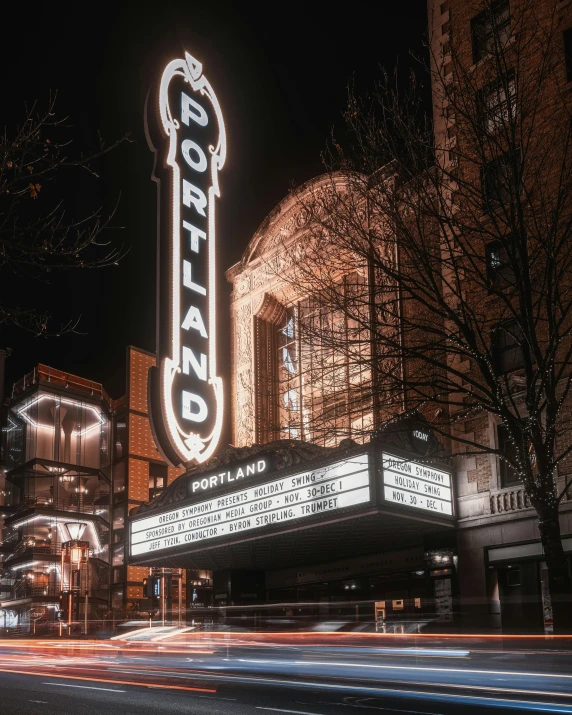 a large marquee sign on the side of a building, a photo, pexels contest winner, portland oregon, theatrical lighting, palatial scene, profile image