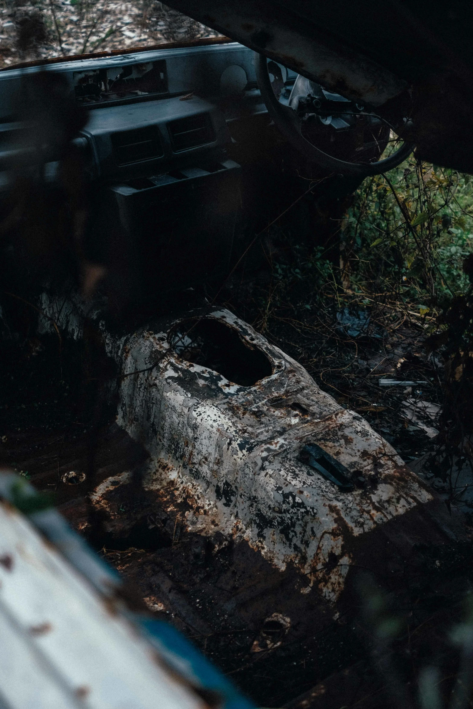 a car that is sitting in the dirt, inspired by Elsa Bleda, unsplash contest winner, auto-destructive art, corpses floor, exposed inner structure, high angle close up shot, video game still