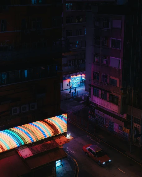 a street filled with lots of traffic next to tall buildings, an album cover, inspired by Elsa Bleda, pexels contest winner, pixel art, bisexual lighting, hong kong buildings, space seen outside from a window, colorful and dark