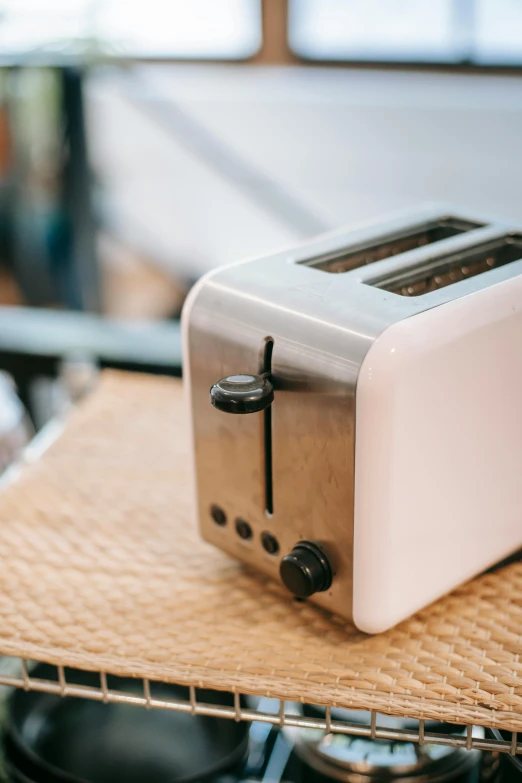 a white toaster sitting on top of a counter, by Everett Warner, trending on pexels, vehicle, brown, rectangle, stainless steel