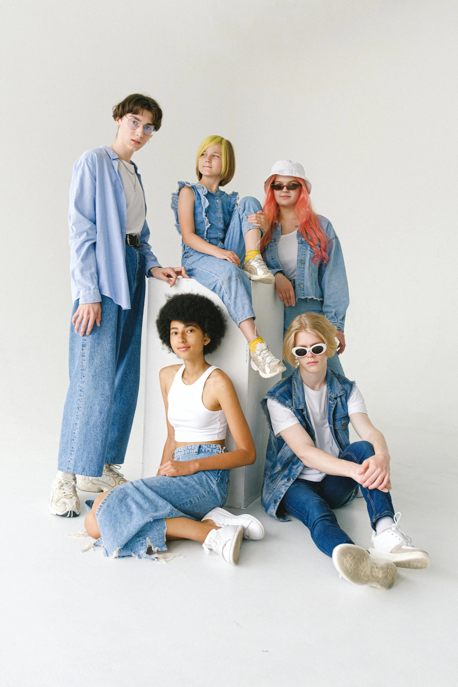 a group of people posing for a picture, by Ellen Gallagher, trending on pexels, aestheticism, denim, pastel clothing, woman model, androgyny