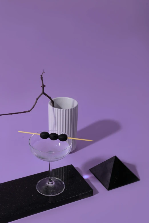 a white vase sitting on top of a table, a still life, inspired by Robert Mapplethorpe, unsplash, suprematism, purple and black color scheme, cocktail bar, flying black marble balls, chopsticks