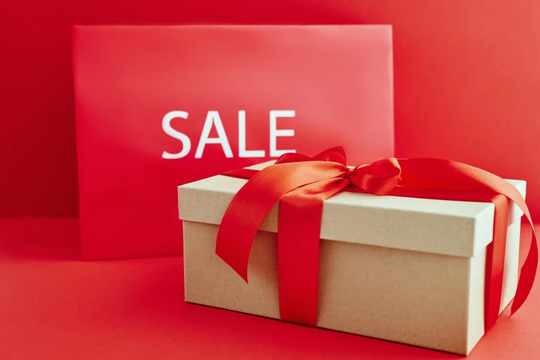 a gift box with a red ribbon and a sale sign, by Eden Box, cosy, thumbnail, alternate angle, 3 pm