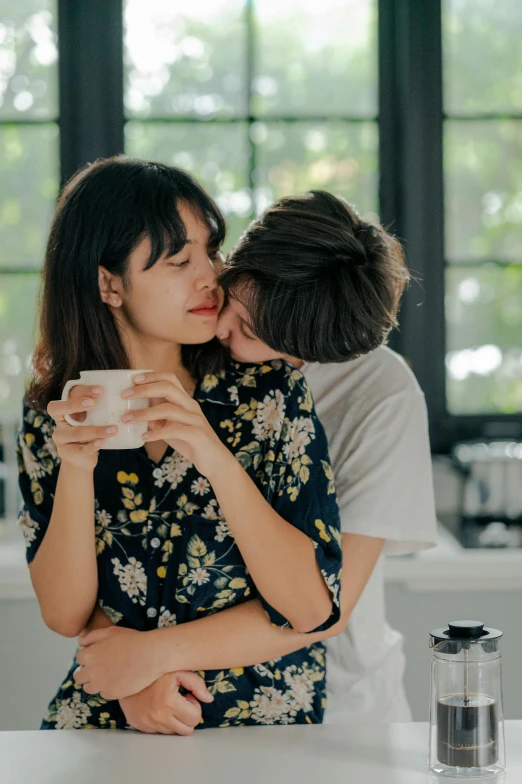 a man kissing a woman in a kitchen, trending on pexels, coffee cup, half asian, lesbian embrace, gif