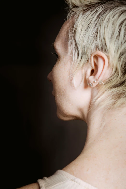 a close up of a person with short hair, by artist, trending on pexels, left ear, full body dramatic profile, non-binary, a blond