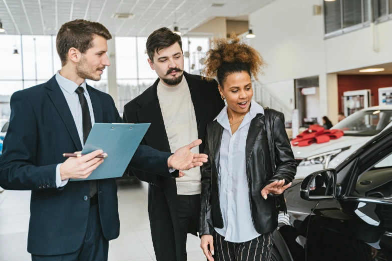 three people looking at a car in a dealers showroom, pexels contest winner, alana fletcher, lachlan bailey, selling insurance, a group of people