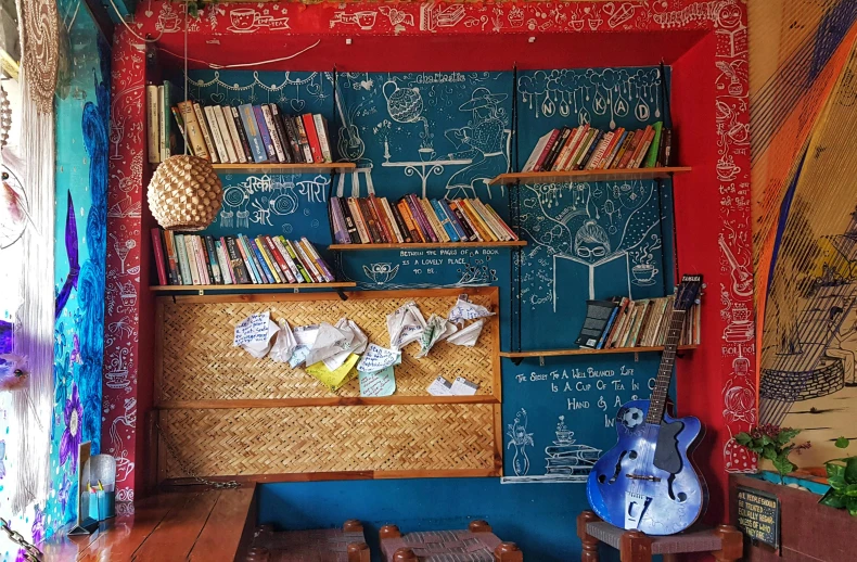 a room with a book shelf filled with books, bengal school of art, chalkboard, rustic, profile image, hippie pad