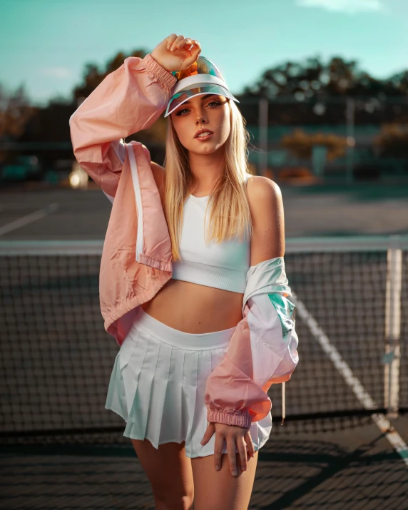 a woman standing on top of a tennis court holding a racquet, an album cover, unsplash, bra and shorts streetwear, pastel lighting, white baseball cap, wearing jacket and skirt