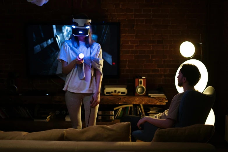 two people in a living room playing a video game, inspired by Jules Chéret, interactive art, vr helmet, shot on sony a 7, low cinematic lighting, avatar image