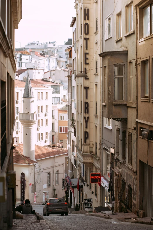 a city street filled with lots of tall buildings, inspired by Nadim Karam, renaissance, ottoman empire, white pale concrete city, brown, alleys