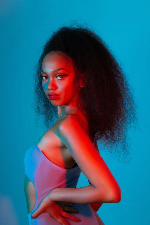 a woman standing in front of a blue background, an album cover, red glowing skin, 2 4 year old female model, arian mark, neon backlighting