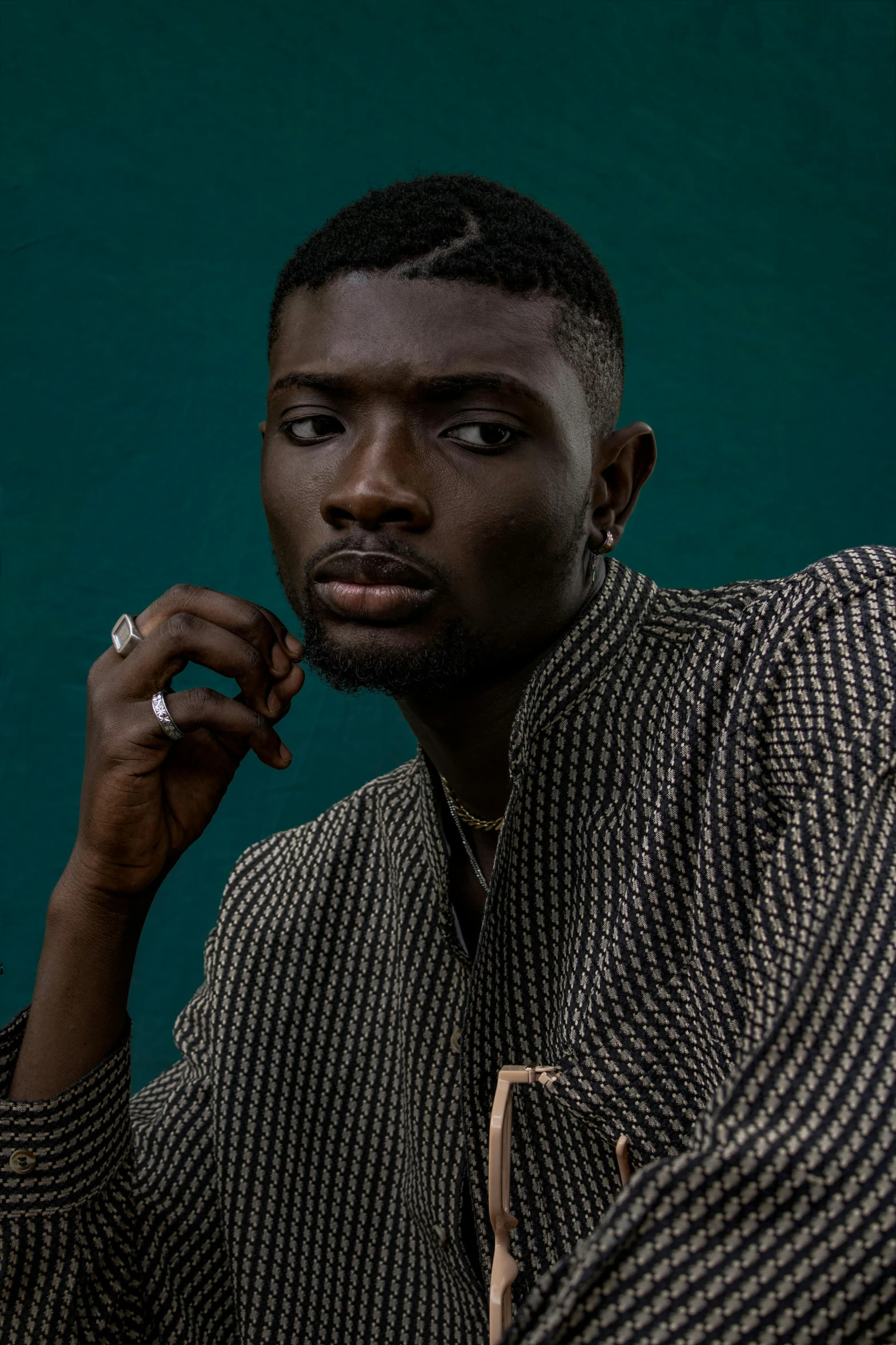 a man sitting down talking on a cell phone, an album cover, inspired by David Bailly, trending on pexels, realism, brown buzzcut, model posing, brom gerald, looking straight to camera