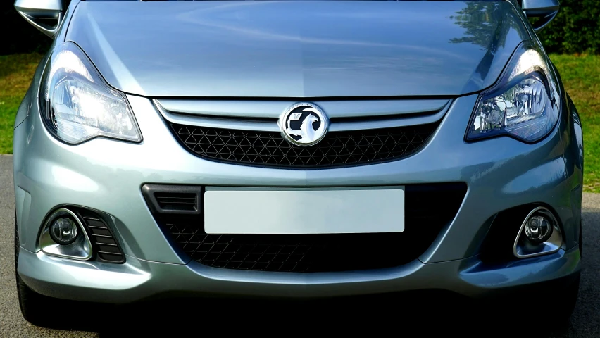 a silver car parked on the side of the road, full face frontal centred, black matte finish, silver insignia, aftermarket parts