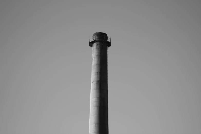 a black and white photo of a tall chimney, unsplash, industrial colours, long neck, circular, blank