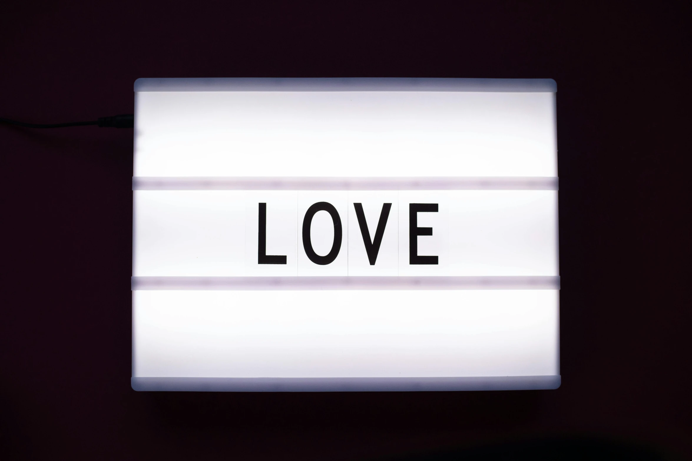 a light box with the word love written on it, by Joe Bowler, unsplash, quality cinema model, without text, panel, white