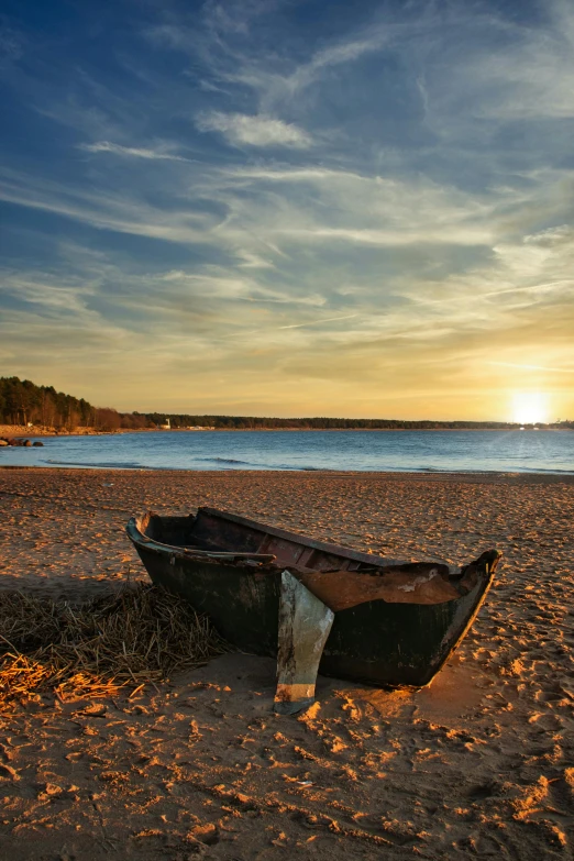 a boat sitting on top of a sandy beach, which shows a beach at sunset, archipelago, at the beach