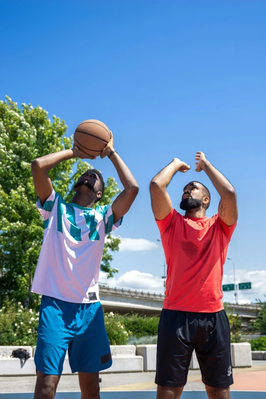 a couple of men standing on top of a basketball court, by Washington Allston, trending on dribble, happening, on a sunny day, hands in the air, wearing basketball jersey, full product shot