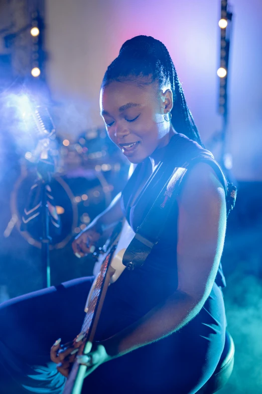 a woman sitting on a stool playing a guitar, photo of a black woman, flashing lights, profile image, bassist