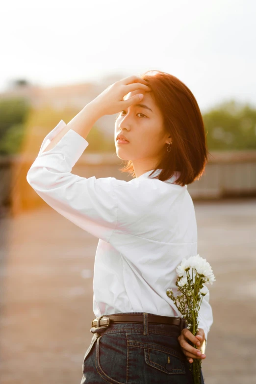 a woman standing in a parking lot holding a bunch of flowers, by Tan Ting-pho, aestheticism, wearing white shirt, looking off into the sunset, thoughtful ), xiang duan