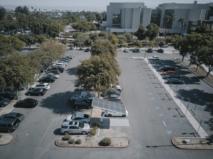 a parking lot filled with lots of parked cars, unsplash, realism, galaxy center remotely visible, school courtyard, lv, no shade