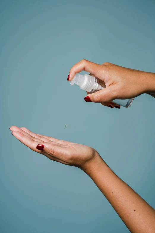 a woman holding a bottle of hand sanitizer, a picture, by Gavin Hamilton, shutterstock, square, soap bubble, product shoot, foam