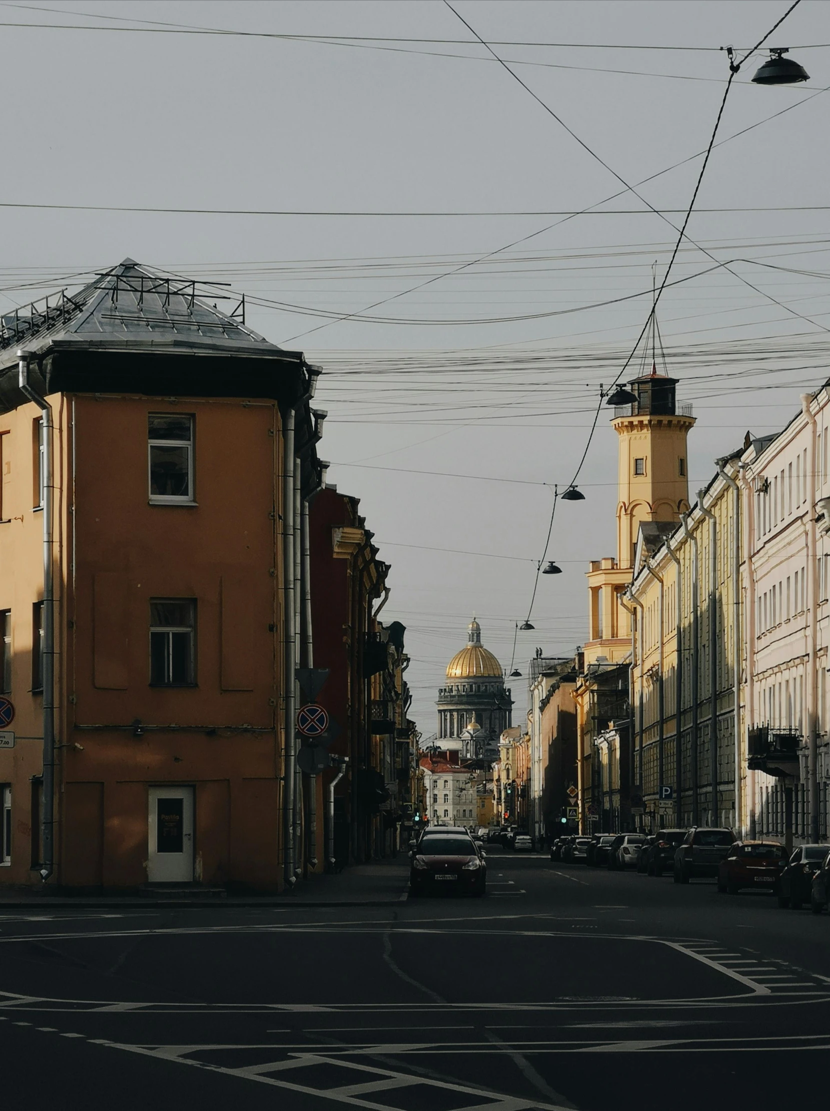 a street filled with lots of traffic next to tall buildings, by Andrei Kolkoutine, pexels contest winner, neoclassicism, saint petersburg, neoclassical tower with dome, wires hanging above street, 000 — википедия