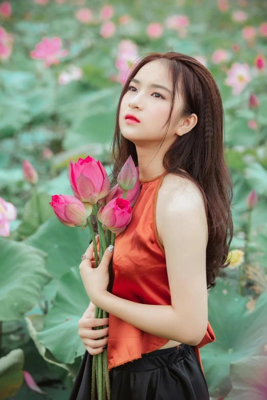 a woman standing in a field of flowers, a picture, by Tan Ting-pho, standing gracefully upon a lotus, holding a red rose, avatar image, square