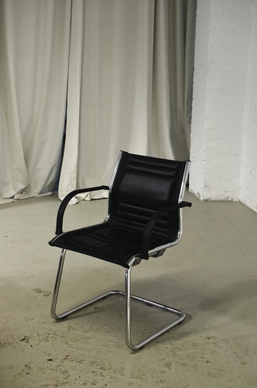 a black chair sitting in front of a white curtain, by Niels Lergaard, reddit, backrooms office space, 3/4 front view, anton migulko, high angle view