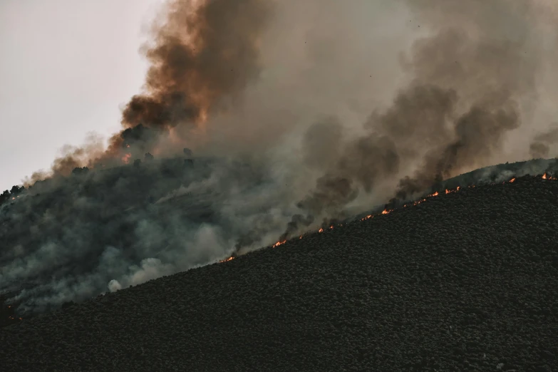 a large plume of smoke rising from the top of a mountain, pexels contest winner, figuration libre, burning fire embers, high quality photo, smokey burnt envelopes, smoke - filled ， green hill