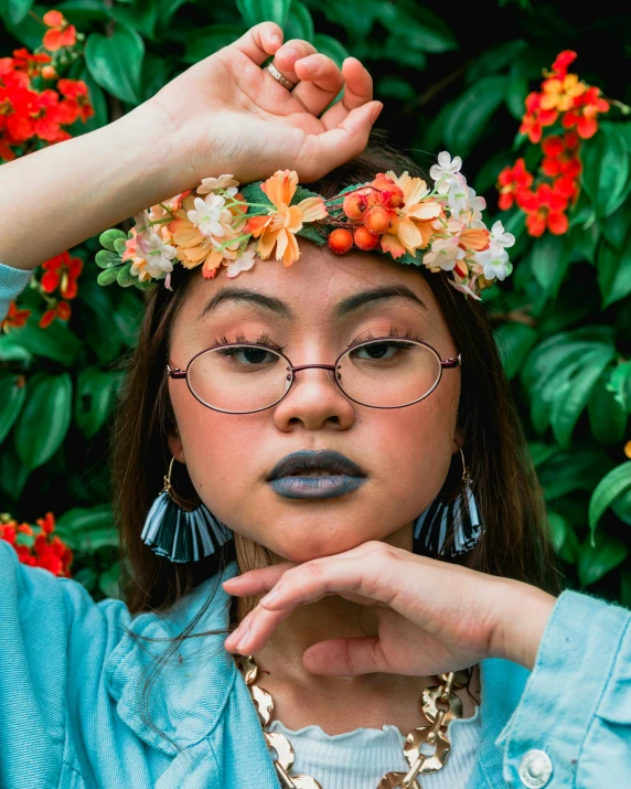 a woman with a flower crown on her head, inspired by Ruth Jên, trending on unsplash, with square glasses, blueberry and orange and teal, asian descent, non binary model