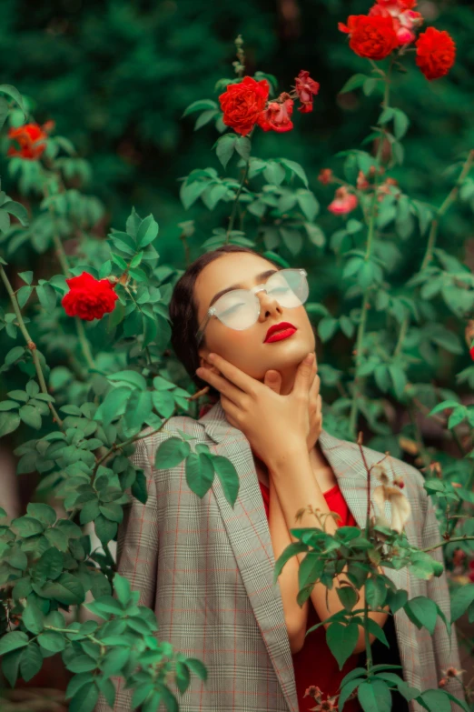 a woman in a red dress is surrounded by roses, inspired by Elsa Bleda, trending on pexels, aestheticism, with square glasses, lush green, girl in a suit, mai anh tran