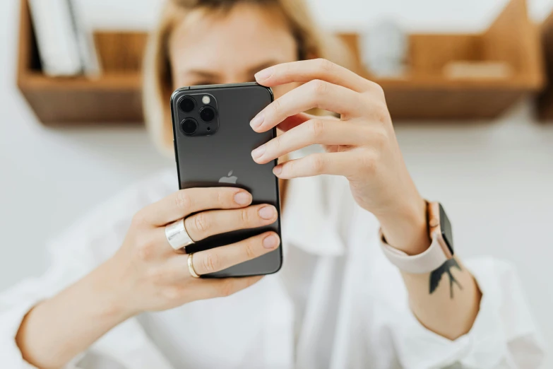 a close up of a person holding a cell phone, a picture, by Julia Pishtar, trending on pexels, photoshoot for skincare brand, flat minimalistic, 1450, various posed