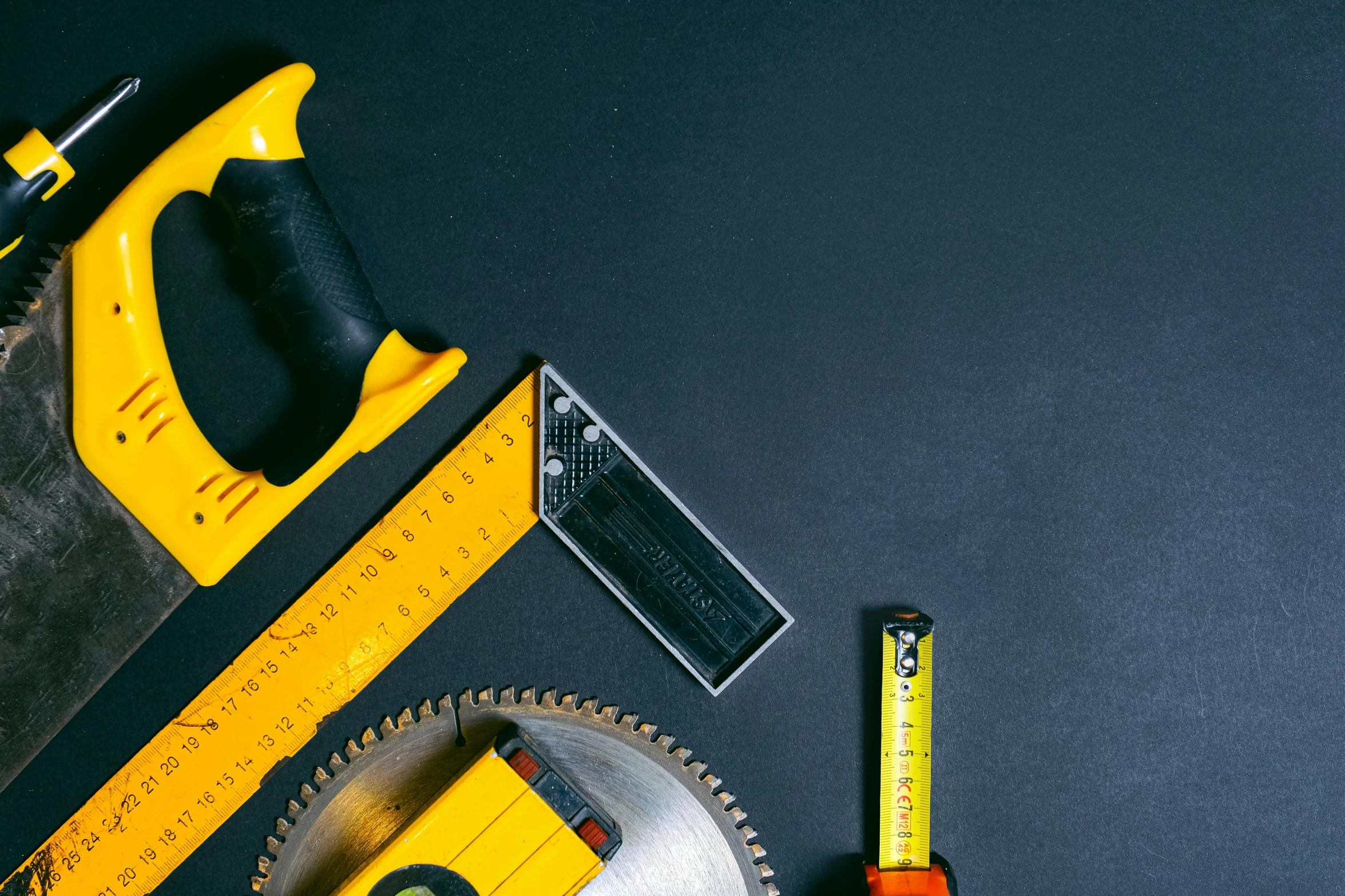 a couple of tools sitting on top of a table, black and yellow, profile image, construction, circular