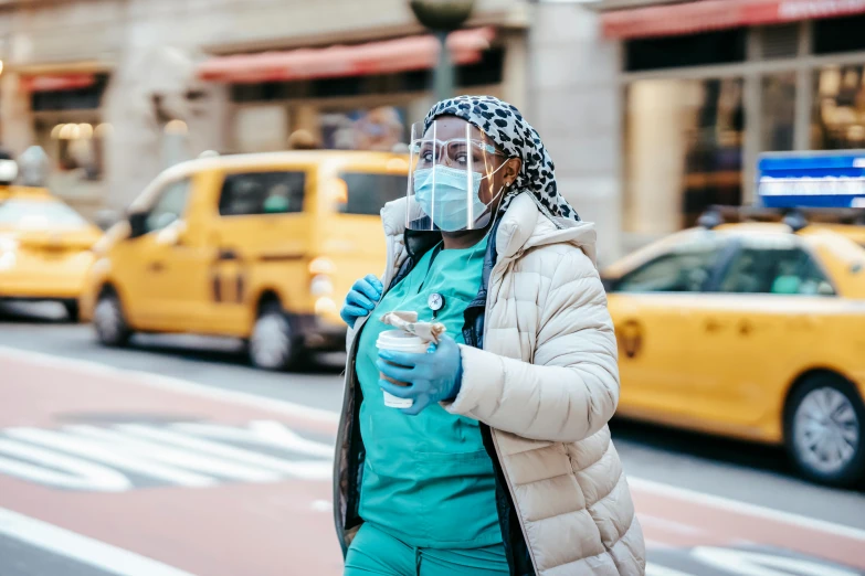 a woman wearing a face mask on a city street, by Meredith Dillman, trending on pexels, nurse costume, nyc, thumbnail, freezing