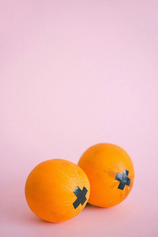 two oranges sitting next to each other on a pink surface, by Ellen Gallagher, trending on pexels, energy spheres, clear cross hatching, full view blank background, stick and poke