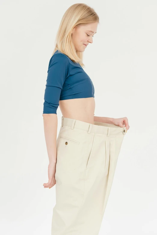 a woman standing with her hands in her pockets, pexels contest winner, renaissance, bent - over posture, khakis, 15081959 21121991 01012000 4k, big complex belly mechanism